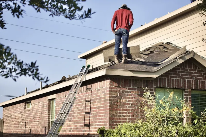 Professional roofer working on a residential roof in Heathrow